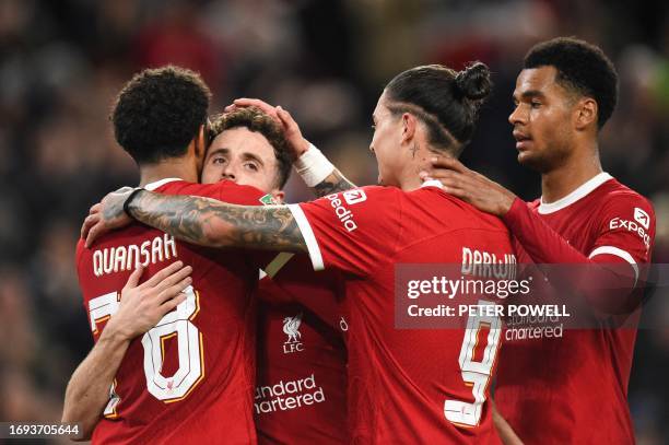 Liverpool's Portuguese striker Diogo Jota celebrates with teammates after scoring his team third goal during the English League Cup third round...