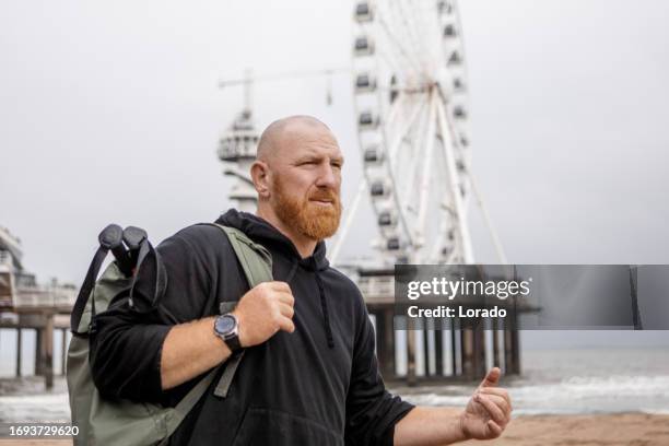 a redhead male working out on the beach - scheveningen stock pictures, royalty-free photos & images