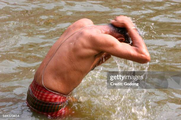 High-caste wearing a brahmin's thread bathing in Kali temple