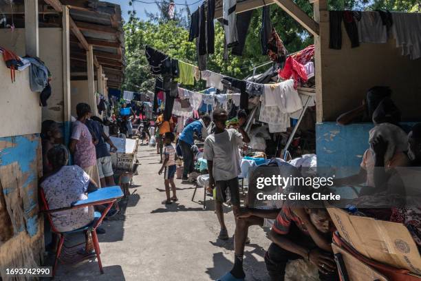 Displaced men, women, and children now live at a school in downtown Port-au-Prince after fleeing their homes during gang attacks on September 12,...