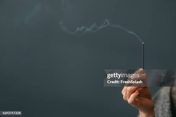 woman in kimono with burning incense stick, a close up - wierook stockfoto's en -beelden