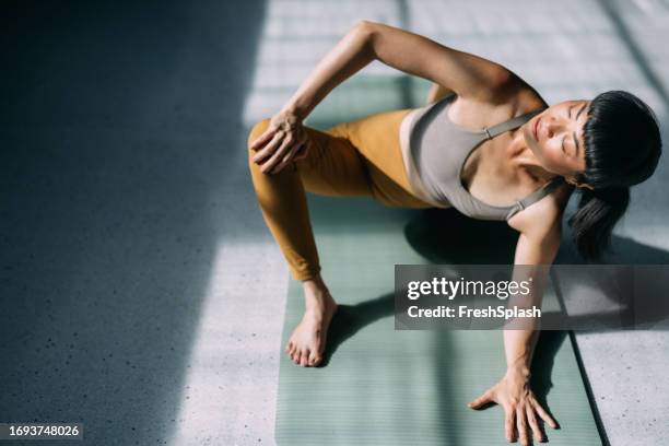 harmony of body and mind: japanese woman's yoga for wellness - vitality wellbeing stock pictures, royalty-free photos & images