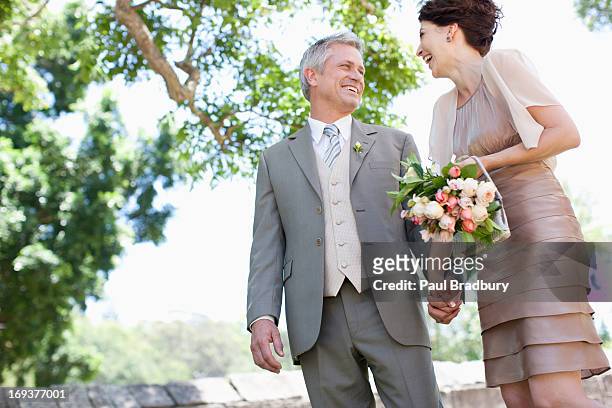 bride and groom holding hands - wedding couple laughing stock pictures, royalty-free photos & images