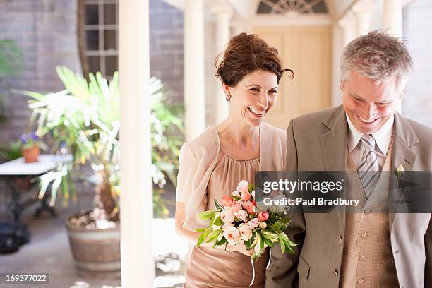 mature bride and groom smiling - huwelijkspartij stockfoto's en -beelden