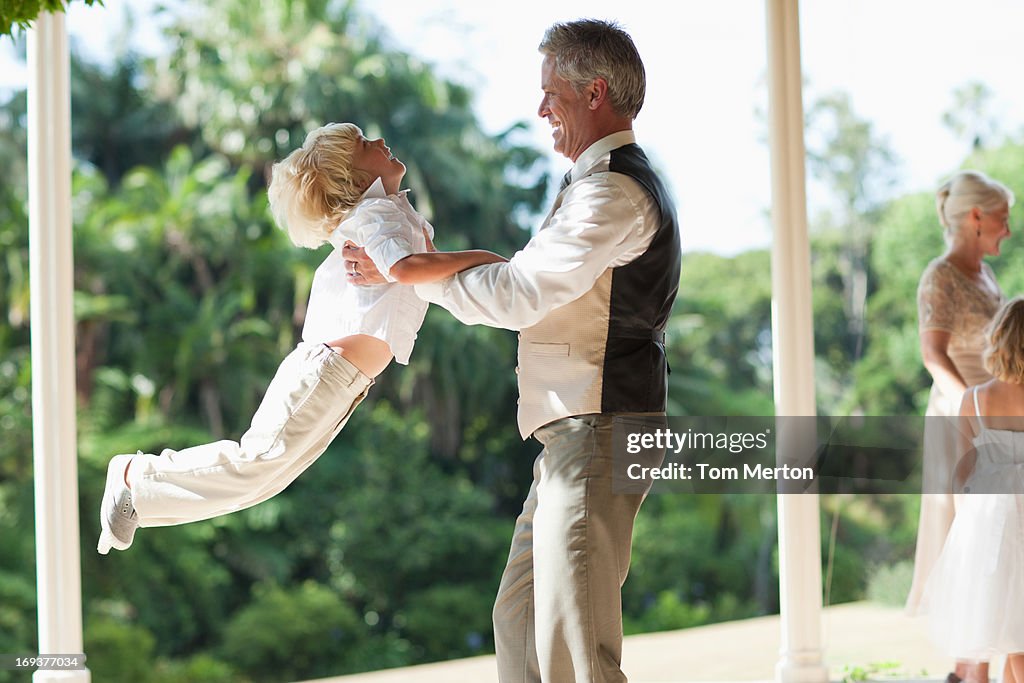 Father lifting son