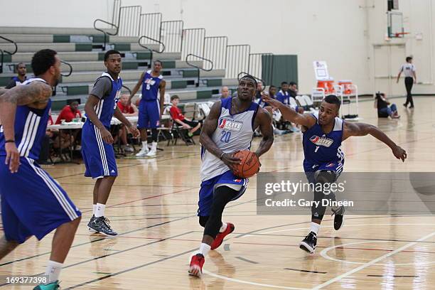 Jermaine Taylor of the Maine Red Claws drives to the basket against Reggie Hamilton of the Idaho Stampede in the NBADL Elite Mini Camp on May 14,...