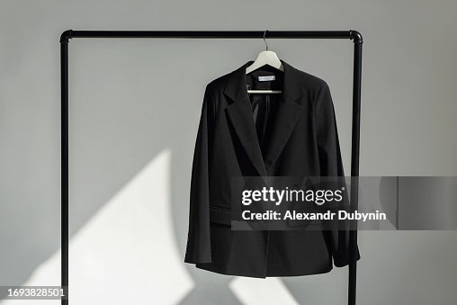 Classic black jacket hanging on the shoulder on a rail. Classic black jacket hanging on the shoulder on a rail.