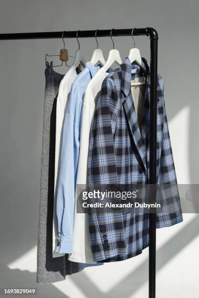 wardrobe clothes hanging on hangers on a rail. clothes sale concept. - coat hanging stock pictures, royalty-free photos & images