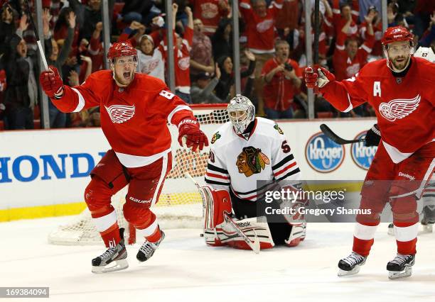 Justin Abdelkader and Pavel Datsyuk of the Detroit Red Wings celebrate a second period goal by teammate Jakub Kindl in front of Corey Crawford of the...