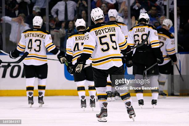 Matt Bartkowski , Torey Krug, Johnny Boychuk and Jaromir Jagr of the Boston Bruins skate off of the ice after they lost 4-3 in overtime against the...