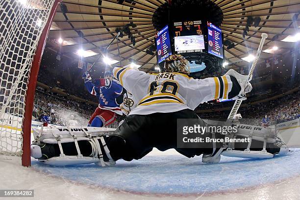 Chris Kreider of the New York Rangers celebrates after he scored the game-winning goal in overtime against goalie Tuukka Rask of the Boston Bruins to...