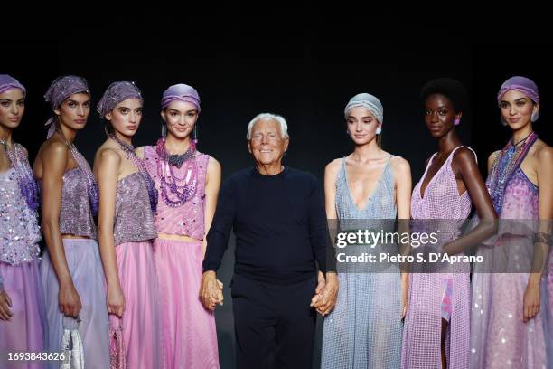 Fashion designer Giorgio Armani and models acknowledge the applause of the audience at the Emporio Armani fashion show during the Milan Fashion Week...