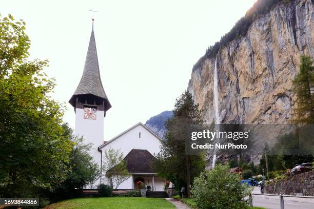 Lauterbrunnen church in front of Staubbach Falls the most visited waterfall of Lauterbrunnen, where farmers across Switzerland return their herds of...