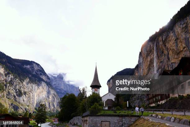 Lauterbrunnen church in front of Staubbach Falls the most visited waterfall of Lauterbrunnen, where farmers across Switzerland return their herds of...