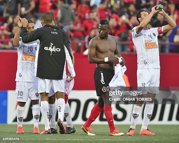 Duvier Riascos of Mexico´s Tijuana leaves the pitch as players of Brazilian Atletico Mineiro celebrate at the end of their Copa Libertadores...