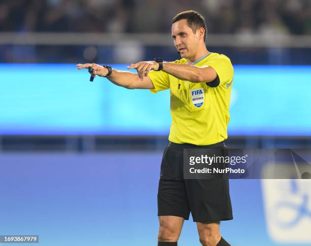 Uzbekistan referee Lutfullin Rustam gestures during the 19th Asian Games Hangzhou match between China and Qatar Huanglong Sports Centre Stadium in...