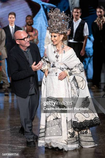 Italian fashion designer Antonio Marras and American actress and former model Marisa Schiaparelli Berenson say goodbye after the fashion show. Milan...