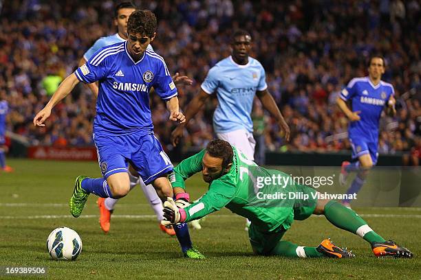 Oscar of Chelsea scores a goal against Richard Wright of Manchester City during a friendly match at Busch Stadium on May 23, 2013 in St. Louis,...