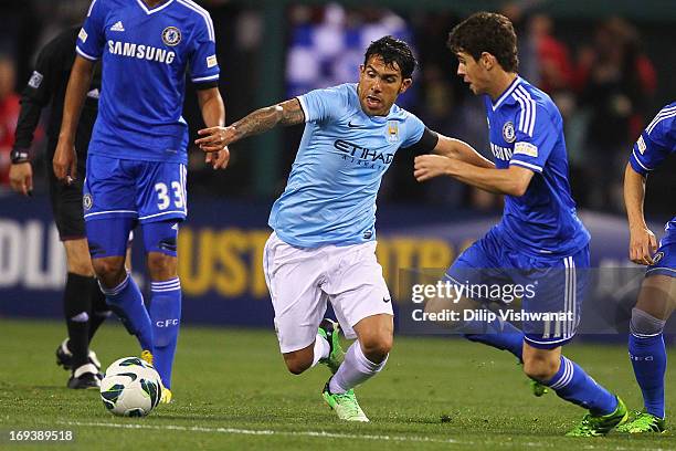 Carlos Tevez of Manchester City looks to beat Oscar of Chelsea to a loose ball during a friendly match at Busch Stadium on May 23, 2013 in St. Louis,...