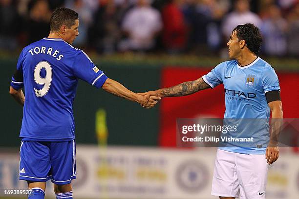 Fernando Torres of Chelsea shakes hands with Carlos Tevez of Manchester City after playing during a friendly match at Busch Stadium on May 23, 2013...