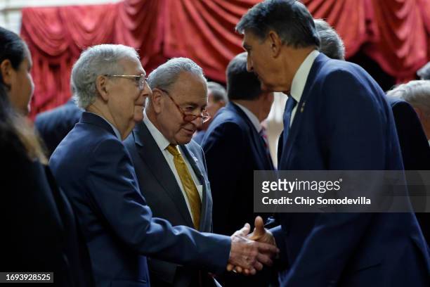 Sen. Joe Manchin greets Senate Minority Leader Mitch McConnell and Senate Majority Leader Charles Schumer following a meeting with Ukrainian...