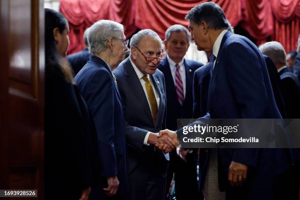 Sen. Joe Manchin greets Senate Minority Leader Mitch McConnell and Senate Majority Leader Charles Schumer following a meeting with Ukrainian...