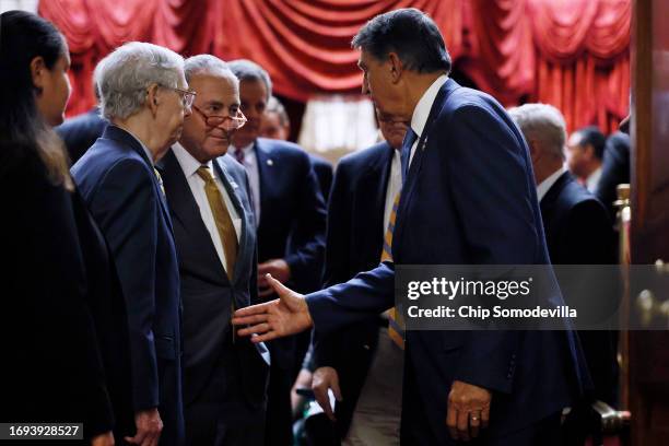 Sen. Joe Manchin greets Senate Minority Leader Mitch McConnell and Senate Majority Leader Charles Schumer following a meeting with Ukrainian...