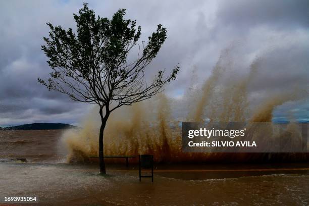 Waves break on a flooded street in Porto Alegre, Brazil on September 27, 2023. The state of Rio Grande do Sul suffered a cyclone that destroyed the...