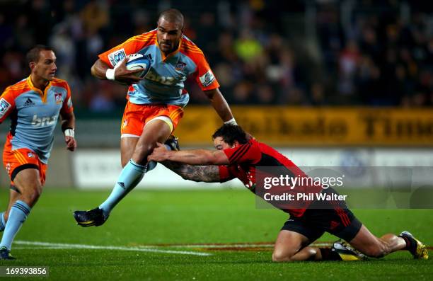 Patrick Osborne of the Chiefs is tackled by Zac Guildford of the Crusaders during the round 15 Super Rugby match between the Chiefs and the Crusaders...