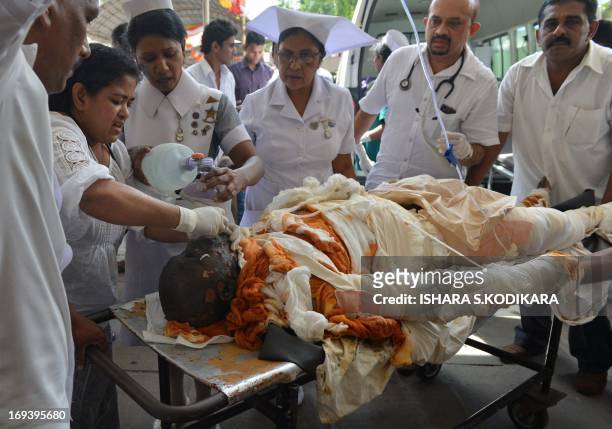 Sri Lankan Buddhist monk Bowatte Indaratane, seen covered in bandages after he self-immolated in Kandy, is brought to the country's main hospital in...