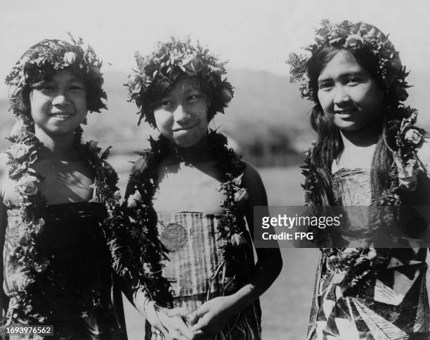 Group of Hawaiian girls, each wearing floral garlands and floral headdresses, Hawaii, circa 1935.