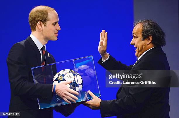 President of The FA Prince William, Duke of Cambridge is presented a match ball by UEFA President Michel Platini during the UEFA Congress at the...