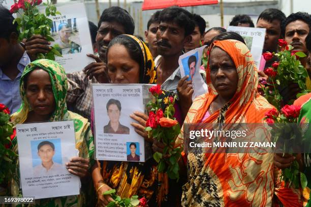 Bangladeshi family members of missing garment workers pay tribute to the victims at the site of the April 2013 Rana Plaza garment building collapse...