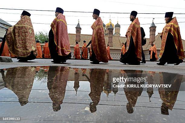 Russian Orthodox priests take part in a religious procession marking Saints Cyrilius and Methodius' Day in central Moscow, on May 24, 2013. The...