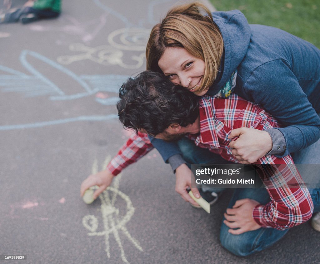 Middle-aged couple drawing on ground