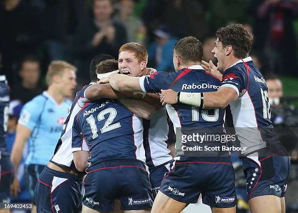 The Rebels celebrate at the final whistle after winning the round 15 Super Rugby match between the Rebels and the Waratahs at AAMI Park on May 24,...