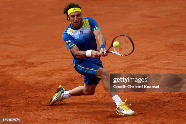 Juan Monaco of Argentina plays a backhand during the Power Horse World Team Cup semi-final between Guido Pella of Argentina and Juan Monaco of...