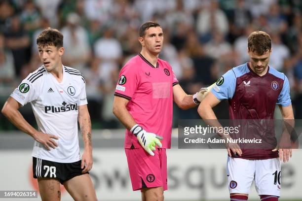 Emiliano Martinez of Aston Villa interacts with teammate Calum Chambers during the UEFA Europa Conference League 2023/24 group stage match between...
