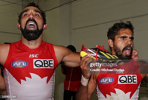 Adam Goodes and Lewis Jetta of the Swans shows off his Indigenous coloured boots made for Indigenous Round during an AFL match between the...