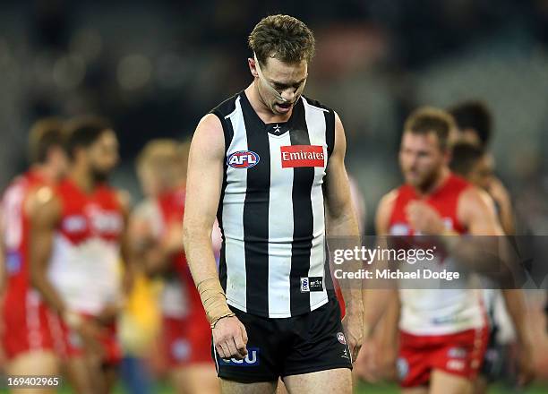 Captain Nick Maxwell of the Magpies leads the team off after losing the round nine AFL match between the Collingwood Magpies and the Sydney Swans at...