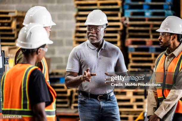 warehouse supervisor speaking with a group of employees - loading dock stock pictures, royalty-free photos & images