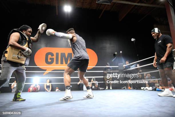 Francis Ngannou trains with coaches Mike Tyson and Dewey Cooper at the Tyson Fury vs. Francis Ngannou open workout on September 26 at Ngannou's...