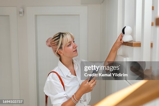 Beautiful woman leaving her house and locking the door using a home automation system Beautiful woman leaving her house and locking the door using a home automation system