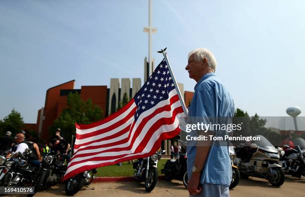 Larry Cory displays an American flag outside the funeral for nine-year-old tornado victim Nicholas McCabe on May 24, 2013 in Moore, Oklahoma. A...
