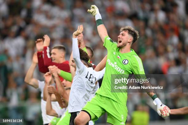 Kacper Tobiasz of Legia Warszawa celebrates victory with teammates following the UEFA Europa Conference League 2023/24 group stage match between...