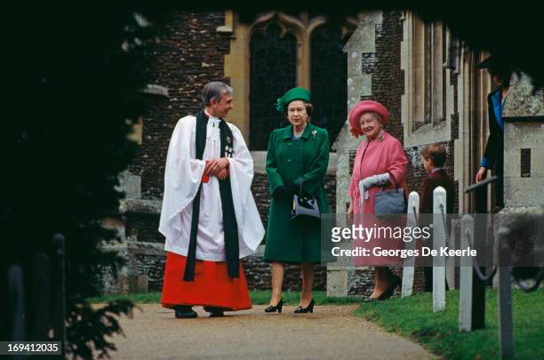 Queen Elizabeth II, the Queen Mother and Prince William walking with the vicar of St. Mary Magdalene Church on Christmas Day whilst the Royal Family...