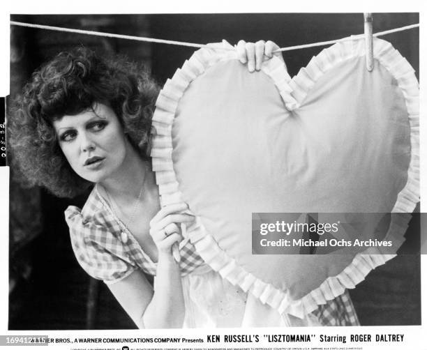 Fiona Lewis with heart pillow on clothes line in a scene from the film 'Lisztomania', 1975.