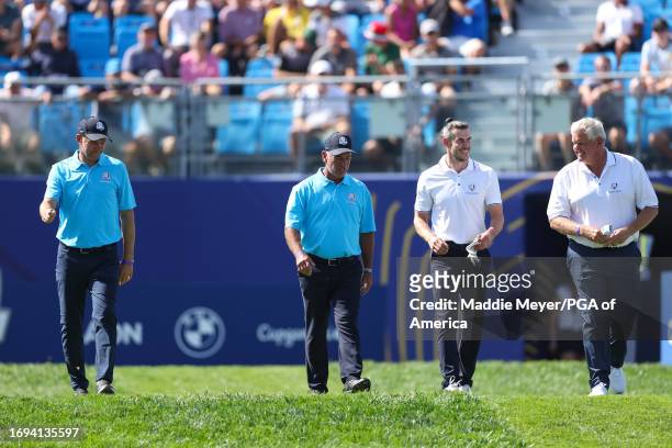 Andriy Shevchenko, Corey Pavin, Gareth Bale, and Colin Montgomerie walk on the first hole at the All-Star Match during the Ryder Cup at Marco Simone...