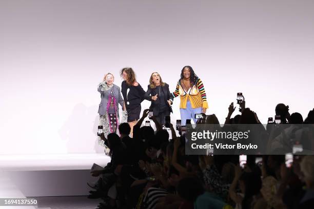 Carlyne Cerf de Dudzeele, Gabriella Karefa-Johnson, Lucia Liu and Katie Grandat acknowledge the applause of the audience at the Moschino fashion show...