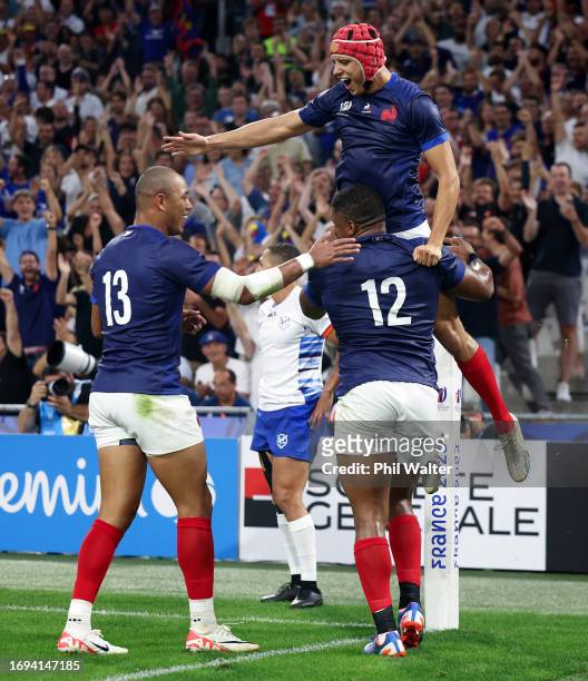 Jonathan Danty of France celebrates with Gael Fickou and Louis Bielle-Biarrey of France after scoring his team's second try during the Rugby World...